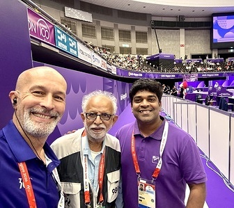Abhilash Rathnakaran (R) Ceremony Manager for Gymnastics is seen with his team during meticulous preparations for a victory ceremony of 20th Asian Games . Arranging the national flags and medals at the 20th Asian Games Aichi-Nagoya 2026. The ceremony team works closely with Media Manager Marcello Bravo to ensure the smooth and efficient conduct of medal ceremonies and facilitate photographers’ access and positioning during the presentations.
