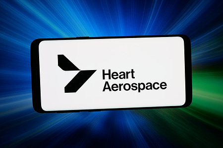 In this photo illustration, the logo of aircraft company Heart Aerospace AB is displayed on a smartphone in front of abstract background on computer screen.