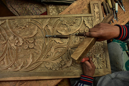 A Kashmiri artisan carves a handicraft item at a wood carving factory. Kashmir, the paradise on earth, refers to the region's breathtaking natural beauty and traditional handicrafts. Along with many other types of art, Kashmir is renowned for its unique wood carving technique. Kashmiri wood carving is in high demand both inside and outside the state. Its market has grown both locally and globally over the years. But nowadays, the artisans are struggling to keep this art alive. Most of the products made by these craftsmen are not fetching enough profit, due to which this noble profession might become extinct in the next few years.