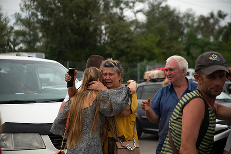 Family members embrace at the refugee center in Ukraine after reuniting. Zaporizhzhia continues to be a main crossing point for refugees fleeing the violence. Fear of increased violence and the nuclear plants strategic interest has left the region on the edge.