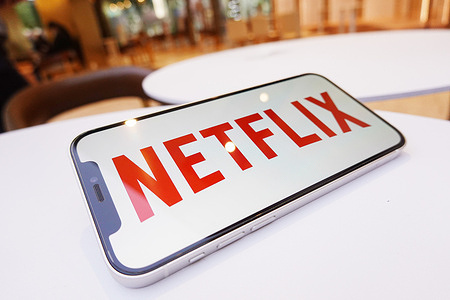 In this photo illustration, a Netflix logo is displayed on the screen of a smartphone.