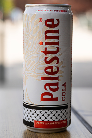 In this photo illustration, a can of Palestine Cola soft drink is seen on a table. Safad Food AB, the parent company of Palestine Drinks, donates 100% of its profits to humanitarian efforts in Palestine. The company is engaged in social initiatives focusing on sustainability and community support through the sale of its beverages.