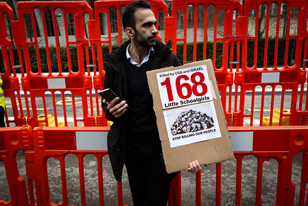 A man holding a placard stands outside the American Embassy after a protest about the bombing of Iran. A week ago, America and Israel started a bombing campaign in Iran targeting military infrastructure. The aim is to topple the regime and stop the country from developing nuclear weapons. Iran's Supreme Leader, Ayatollah Ali Khamenei, who has led the country since the Iranian Revolution in 1979, was killed in the first wave of the attack. Hundreds of civilians, including 160 school girls, have been reportedly killed, prompting human rights groups to take to the streets to protest yet another war in the Middle East.
