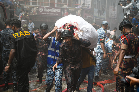 Border Guard Bangladesh (BGB) and Air Force personnel help business owners to bring out their goods from the site of a fire at the clothing market in Dhaka. A large fire has gutted thousands of shops at a popular clothing market in the Bangladeshi capital, Dhaka, with shop owners devastated by the loss weeks before Eid, the Muslim festival marking the end of Ramadan. Hundreds of firefighters and army personnel battled the inferno as it tore through the clothing market, turning it into a pile of ashes. Several people have been injured but no deaths have been reported so far. Authorities were still trying to figure out the cause of the blaze.