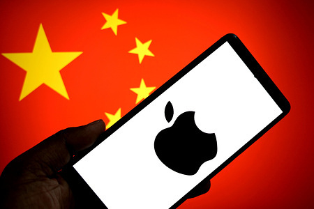 In this photo illustration, an Apple Logo is seen displayed on a smartphone with the Chinese flag in the background.