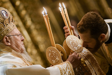 A priest (R) is seen kissing a holy symbol held by the Ecumenical Patriarch Bartholomew I. The Ecumenical Patriarch Bartholomew I celebrated the Easter’s Vigil ceremony at St. George Cathedral, in Fener.