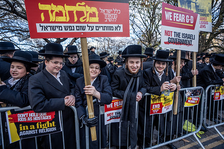 Protesters hold placards expressing their opinion during the demonstration. Haredi Orthodox Jews gathered near the Israeli Embassy in Kensington to protest against the Israeli Army's draft conscription which threatens their religious and pacifist lifestyle centered on Torah study.