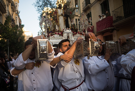 Penitents from 'Prendimiento' brotherhood are seen carrying a float with the statue of Christ as they take part in a procession during the Palm Sunday, to mark the Holy Week celebrations. Thousands of worshippers wait to see the processions with the statues of Christ and the Virgin Mary as part of the traditional Holy Week celebrations. In Andalusia, Easter brings together thousands of people from all over the world and it's considered one of the most important religious and cultural events of the year.