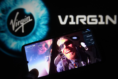 In this photo illustration, British billionaire Richard Branson is seen on a fragment of a Virgin Galactic Unity 22 Spaceflight Livestream Youtube video displayed on a smartphone with the Virgin Galactic logo in the background. 
UK billionaire Richard Branson on July 11 soared more than 50 miles (which marks the boundary of space according to the United States ) aboard his Virgin Galactic VSS Unity space rocket plane and lands safely, reportedly by media.