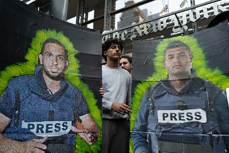 Images of Anas al-Sharif and Hossam Shabat in front of the New York Times building seen during the rally. Protests arose in multiple locations following a deadly Israeli airstrike in Gaza that killed six Al Jazeera journalists, including correspondent Anas al-Sharif.