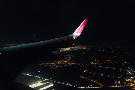 The WizzAir logo is seen on a wingtip in the airspace above the European continent. Spain is anticipating a record-breaking year for tourism in 2026, aiming to surpass the 100 million foreign visitor mark after reaching a record 97 million in 2025. Growth remains strong, with international arrivals projected to increase by 3.7% in early 2026 and tourism revenue expected to reach €35 billion during that period.