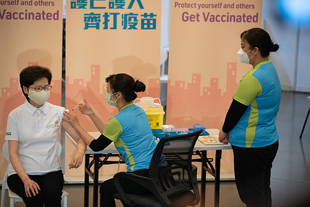 Carrie Lam (L), Hong Kong Chief Executive receives a dose of the COVID-19 vaccine at the Community Vaccination Centre at the Hong Kong Central Library.
Hong Kong Chief Executive Carrie Lam and members of her cabinet receive their first dose of of the COVID-19 vaccine in a bid to boost public confidence to the vaccine as the vaccination program for the public will begin on 26th February.