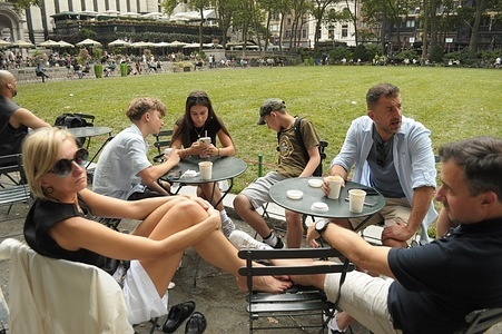People sit at tables in Bryant Park, Manhattan, New York City.