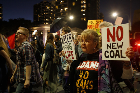 Protesters hold placards during the Uni Students Walkout Against Adani march.
University students and other members of the public protested against the debated Adani coal mine in central Queensland. Numerous members of the Extinction Rebellion had been arrested days before the protests in the city on the 6th of August, and some as per their bail were not allowed within the central business district for several weeks. The protesters marched across Victoria Bridge to meet them at South Bank instead.