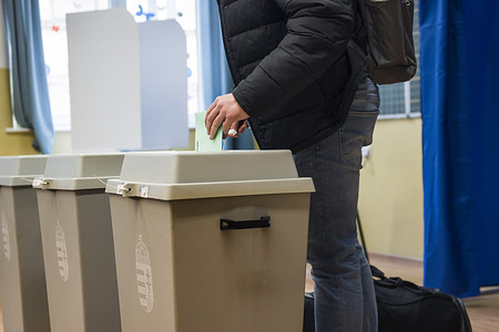 A man cast his ballot at a polling station during the Hungarian parliamentary elections in Budapest. Hungarians began voting at 6:00 a.m. local time on Sunday, April 12, 2026, in what analysts describe as the most consequential election since the country's transition to democracy. After four consecutive terms in power, Prime Minister Viktor Orbán and his ruling Fidesz-KDNP alliance are facing an unprecedented challenge from the Tisza party, led by former government insider turned opposition figure Péter Magyar.
