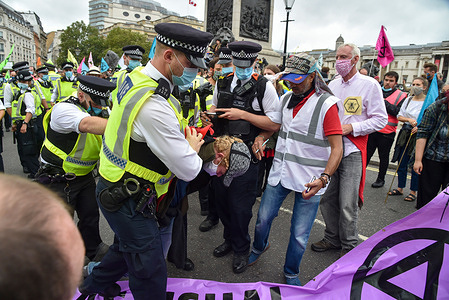 Police arrest a protester at Trafalgar Square during the demonstration.
Extinction Rebellion Carnival of Corruption protesters march from Parliament Square to Trafalgar Square where they held a sit down protest, Police moved in and made arrests. Activists demand for those in power to take action on climate and environment issues.