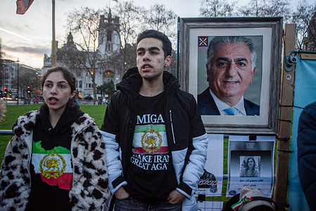 Protesters chant slogans by the photo of the Crown Prince of Iran, Reza Pahlavi during the demonstration outside the Parliament. A small group of Iranian royalists gathered outside the Parliament in London, UK. Protesters want to show their support to the anti-government protesters in Iran. Demonstrators intend to replace the Supreme Leader of Iran, Ayatollah Ali Khamenei and his regime to the Crown Prince of Iran, Reza Pahlavi who lives in exile at the United States.
