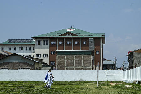Kashmiri school girls walk past a worker painting a red cross symbol over the roof of a hospital as a preventive measure amid the ongoing border tensions. India and Pakistan exchanged heavy artillery along their contested frontier on May 7 after New Delhi launched deadly missile strikes on its arch-rival, in the worst violence between the nuclear-armed neighbours in two decades.