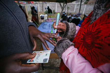 An Independent Independent Electoral and Boundaries Commission (IEBC) official puts ink on a voter's finger after voting in Kenya's general elections on 9th August 2022, at St. Teresa's Primary and Secondary school in Nairobi. Kenyan voters head to the polls. They will elect the president and deputy president, county governors and running mates, members of the Senate, representatives of the National Assembly (including women county representatives) and members of County Assemblies. This year, voting will be held across an estimated 46,232 polling stations.