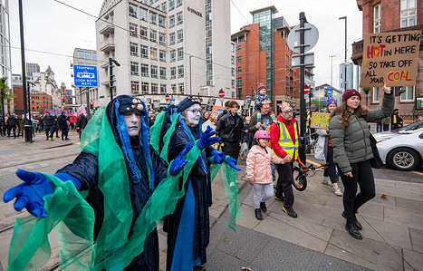 Marine extinction protesters welcome Greater Manchester Climate Justice Coalition demonstration climate event to St peter's square in the city centre. Banners held by protesters included themes on Cop 30, action on carbon emissions, fossil fuels and defending forests. Right wing vloggers and streamers clashed with the marchers and were separated by police.