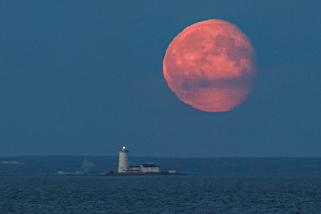 Moonrise over the Gulf of Finland with Tolbukhin Lighthouse in Lebyazhye, Leningrad Oblast, Russia.