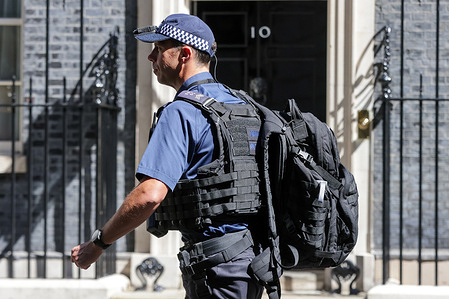 A police officer walks along No 10 Downing Street in Westminster, London.