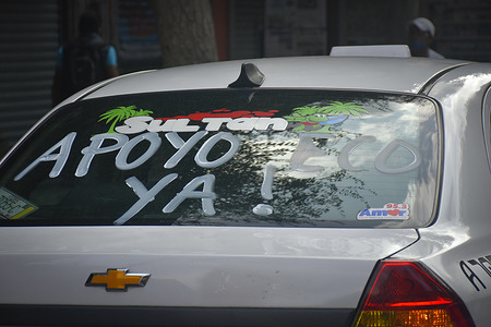 A slogan is seen on the back of a taxi "APOYO YA!" (Support now) during the taxi drivers protest in Mexico.
Taxi drivers protest in demand for financial aid of 25 thousand pesos from the government due to the Covid-19 crisis. The caravan left the monument to the revolution to Zocalo of Mexico City.