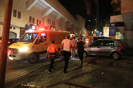 Palestinians and paramedics search for Palestinians wounded during an Israeli army raid in the West Bank city of Nablus. Israeli army and special forces launched a swift operation in which one person was wounded and another Palestinian was arrested.