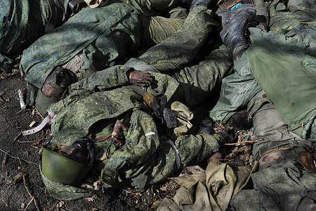 (EDITORS NOTE: Image depicts death) Bodies of eleven Russian soldiers in a mass grave in the Vil'khivka village. According to forensic doctors the bodies has been in decomposition between two to four weeks. Ukrainian soldiers liberated the small village of Vil'khivka outside of Kharkiv were Russian troops recently withdrew following intense fighting with Ukrainian forces. The press was allowed to enter the village few weeks after the fight. Russia invaded Ukraine on 24 February 2022, triggering the largest military attack in Europe since World War II.