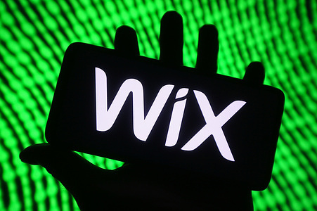 In this photo illustration, WIX (Wix.com Ltd.) logo is seen on a smartphone screen.