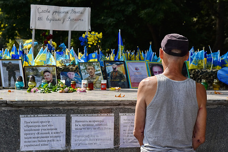 A local resident seen at the memorial site dedicated to the fallen soldiers of Ukrainian armed forces in Zaporizhzhia.