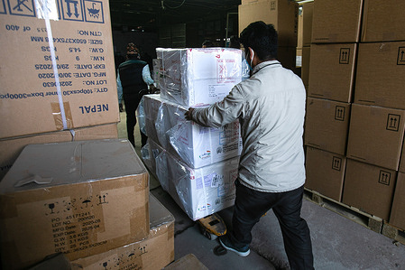 Workers unload the first batch of COVID-19 vaccine, manufactured under license by Serum Institute of India after arrival in Kathmandu.The Government of India provides one million doses of COVID-19 vaccines to Nepal under grant assistance. The vaccines will be inoculated to the frontline health workers, employees, and security personnel in the first phase.