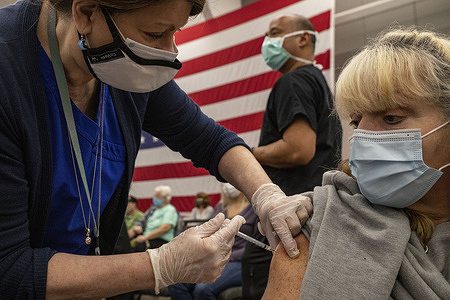 Carolyn Rollins, 62, of Logan, WVa. receives a coronavirus disease (COVID-19) vaccine.
At risk individuals, 65 years or older, were given priority to receive a coronavirus disease (COVID-19) vaccine at the Charleston Convention Center and Coliseum. It was estimated that somewhere between 5,000 and 6,000 people would receive a coronavirus disease (COVID-19) vaccine making this event the largest vaccine event that Kanawha County, West Virginia has ever seen. Both the Pfizer and Moderna vaccine were on hand for older individuals or peoples with compromising conditions.