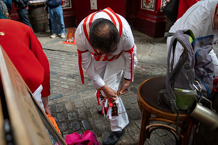 A member of the Ewell St Mary's Morris Men, adjusts his costume before a performance in Leadenhall Market on St George's Day. The Ewell St. Mary's Morris Men performed at Leadenhall Market to mark 2026 St George's Day. The group carried out traditional Morris dances with bells, sticks, and handkerchiefs, accompanied by live music. Shoppers and visitors stopped to watch, as the performance brought a piece of English folk tradition into the City of London during the lunchtime period.