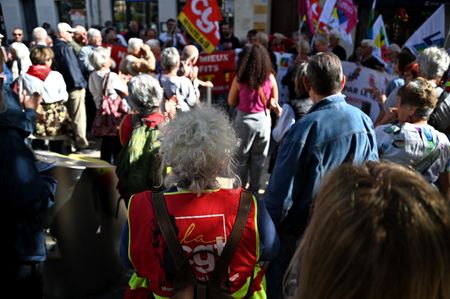 Protesters are listening to a speech delivered by one of their own. At the call of several unions, retirees gathered outside the Movement of the Enterprises of France (MEDEF) to protest against the reduction of their pensions and the destruction of public services.