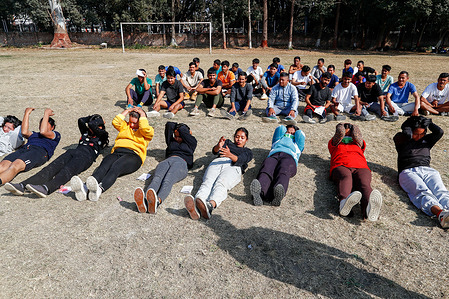 Men and women undergo physical training to be selected as temporary police personnel (Myadi Police) in preparation for the upcoming elections in Kathmandu.