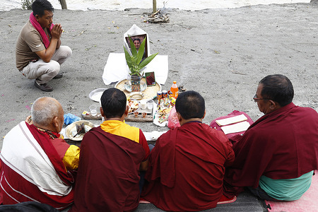 Lok Bahadur Sherpa performs a Buddhist prayer for the soul of his son, Gyamcho Sherpa who remains missing following the devastating flash floods along the Trishuli River. The prayer is performed as the family awaits the recovery of Gyamcho’s body.