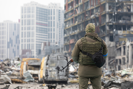 A soldier with a machine gun is on duty near the destroyed Retroville shopping center. Retroville shopping center including its surrounding areas in Kyiv are destroyed after the Russian shelling attack. According to the emergency service, at least six people died during the attack. Russia invaded Ukraine on 24 February 2022, triggering the largest military attack in Europe since World War II.