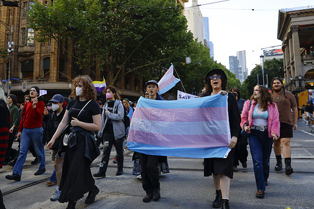 Protesters seen holding flags and banners on the streets as they march through the CBD.  A Trans Day of Vengeance march took place in the CBD with participants rallying against discrimination and violence towards transgender people. Protesters allege that Victoria Police force tried to stop the march leading to heightened tensions between demonstrators and authorities.