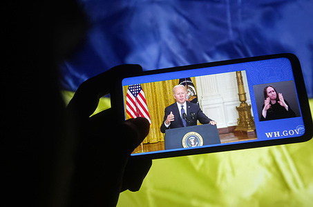 In this photo illustration, a Ukrainian man holds a smartphone in his hand as he looks at U.S. President Joe Biden, giving brief remarks providing an update about the unrest between Russia and Ukraine on YouTube channel.
President of Ukraine Volodymyr Zelensky calls for a 'Day of unity' on February 16. Russia has deployed over 100,000 troops near the Ukrainian border, and the U.S. said Russia might invade any day, reportedly by media.