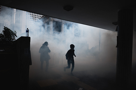 Two woman run through clouds of tear gas during the demonstration.
Thousands of pro-democracy protesters attended an anti-communism rally, the rally ended 3 hours earlier due to police firing tear gas into protesters who eventually dispersed to multiple locations around the city and continued to protest.