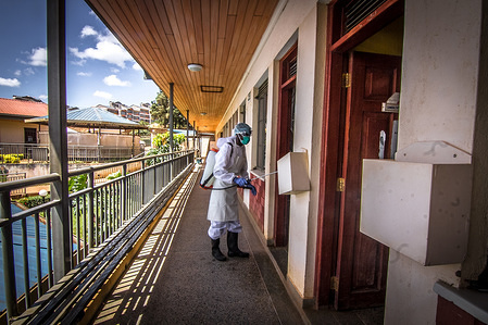 A local health official wearing a protective suit disinfecting a health centre in Kibera Slums during the corona virus pandemic.
Since the covid-19 outbreak, a number of measures to minimise the spread of the corona virus have been adopted such as: disinfection, raising awareness and a national lockdown, people affected have been provided with food aid from organisations like Good Willers before the government banned such charity deeds following an incidence of death.