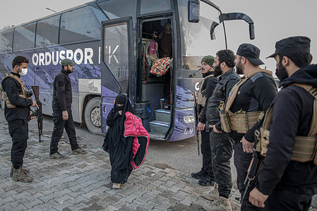 A young girl disembarks a bus that transferred hundreds of people from Al Hol camp in Hasaka Governorate, northeast Syria, to Aq Burhan camp in Aleppo Governorate. After Syrian government forces took control of Al Hol camp in Hasaka province on Jan. 21, 2026, authorities began evacuating the site. Tens of thousands of residents, mostly women and children with alleged ISIS links, are being moved to the Akhtarin camp in Aleppo province, while others are being repatriated. Officials also said more than 10,000 people escaped during the transition, as the government moves to close Al Hol and reassess detainees.