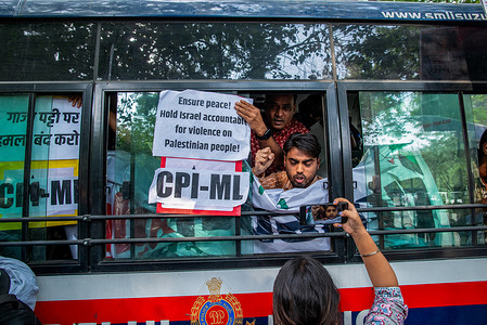 Protesters from India's leftist parties speak to media from inside a police van after the police detained them during the anti-Israel demonstration at Jantar Mantar in New Delhi. Protesters rally in New Delhi, after the October 7th terrorist attacks by Hamas prompted Israel to launch a bombing campaign and to impose a total blockade on the Gaza Strip while urging residents in the northern part of the region to relocate south of the Wadi Gaza wetlands.