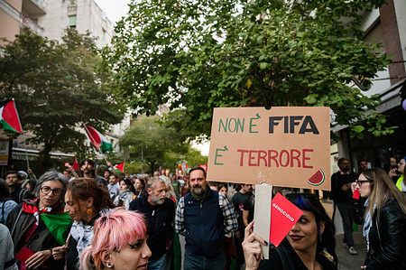 People seen holding signs during the protest. A big rally was organised to protest against the World Football Qualifiers match, between Italy Vs Israel, protesters clashed with police. When Mossad agents showed, the violent protest started showing showing the heavy division between a population that has clear ideas on Israel, genocide and IDF, and the governing agencies (Police, Italian government and FIFA). Italian people have been asking for years to stop collaborating with Israel.