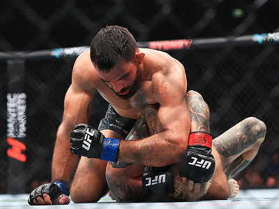 Benoit Saint Denis (L) of France seen in action with Dan Hooker (R) of New Zealand in a lightweight fight during the UFC 325 event at Qudos Bank Arena.