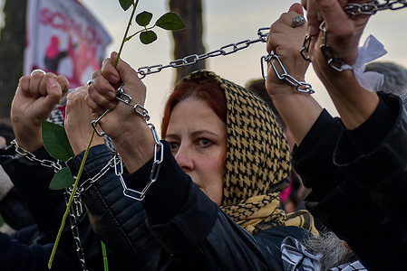 A woman with a chain on her wrist participates in the Non Una Di Meno march for International Women's Day