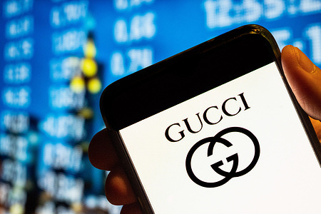 In this photo illustration, the Italian luxury fashion brand Gucci logo is displayed on a smartphone screen.