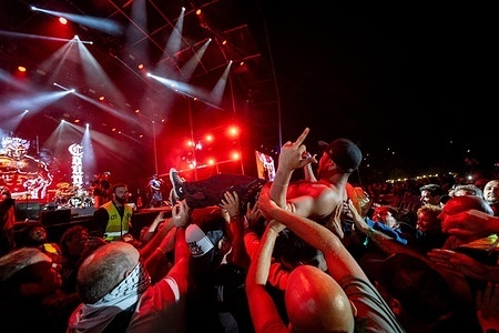 ‎(EDITOR'S NOTE: Image contains profanity)
Tracy Marrow Jr., aka Little Ice, backup vocalist and hype man of the American metal band Body Count, is lifted by festivalgoers and carried in a crowd‑surfing moment during the fifth and final day of the Vilar de Mouros Festival.