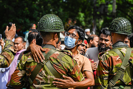 An anti-government protestor celebrates and embraces a soldier in Shahbag near Dhaka University. Thousands of Bangladesh People celebrate the resignation of Bangladeshi Prime Minister Sheikh Hasina. Protests in Bangladesh that began in July for the abolition of the quota system in government jobs culminated on August 5, as Bangladesh military chief Gen. Waker-uz-Zaman announced a transitional government after Prime Minister Sheikh Hasina fled the country due to violent nationwide protests. Hundreds of people were killed and wounded during the protests since July, which first called for the abolition of quotas in government jobs and later the resignation of the Hasina, who had been in power since 2009.